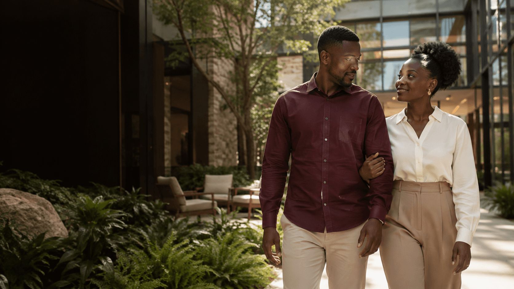 A couple walking together through a calm clinic courtyard